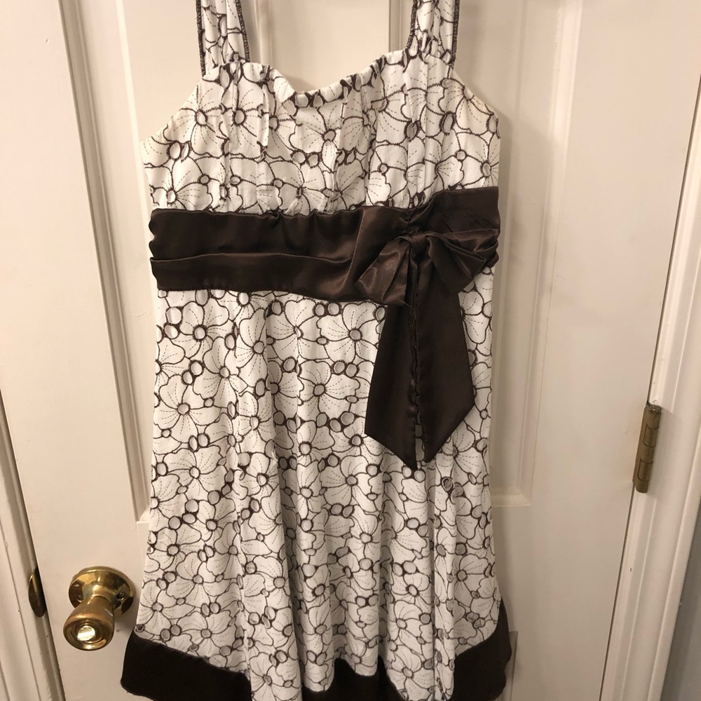 Charming White and Brown Kids Dress with an eye catching floral print.